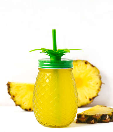 Pineapple juice and slices of fresh pineappleの写真素材