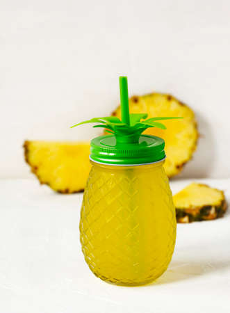 Pineapple juice and slices of fresh pineappleの写真素材