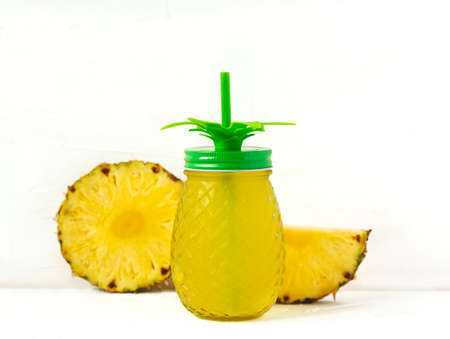 Pineapple juice and slices of fresh pineappleの写真素材