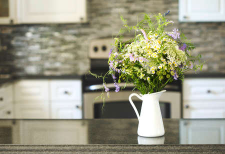 Bouquet of wildflowers in vase on kitchen tableの写真素材