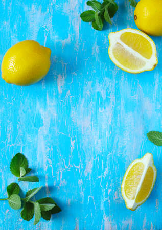Fresh lemon and mint on blue background, copy spaceの写真素材