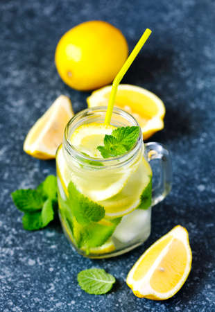 Mason jar glass of lemonade with mint on blue stone backgroundの写真素材