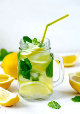 Mason jar glass of lemonade with mint on white backgroundの写真素材