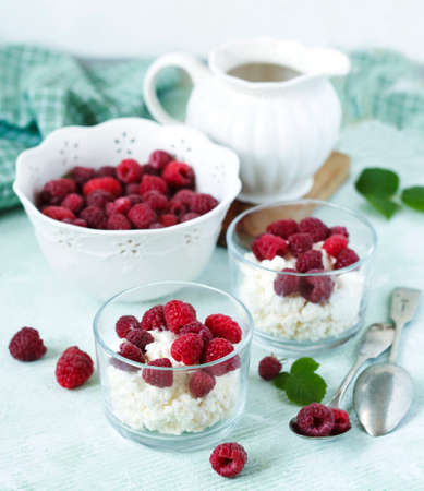 Cottage cheese with fresh raspberry for healthy breakfastの写真素材