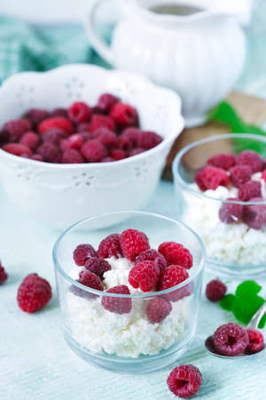 Cottage cheese with fresh raspberry for healthy breakfastの写真素材