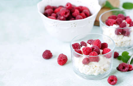 Cottage cheese with fresh raspberry for healthy breakfast, copy spaceの写真素材