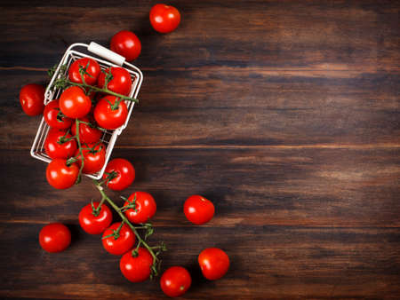 Fresh tomatoes on wooden background, copy spaceの写真素材