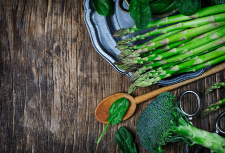 Fresh green vegetables on wooden background with copy spaceの写真素材