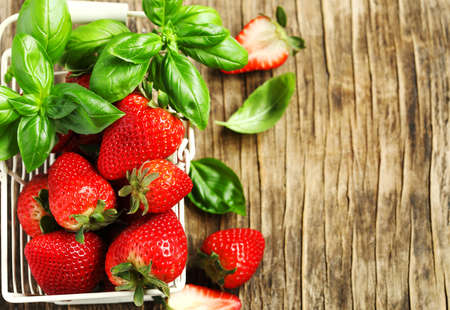 Fresh strawberries and basil on wooden background with copy spaceの写真素材