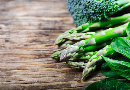 Fresh green vegetables on wooden background with copy spaceの写真素材