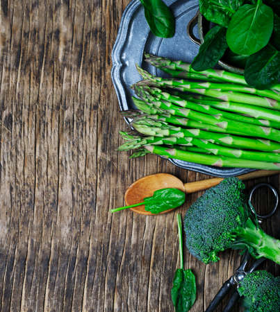 Fresh green vegetables on wooden background with copy spaceの写真素材