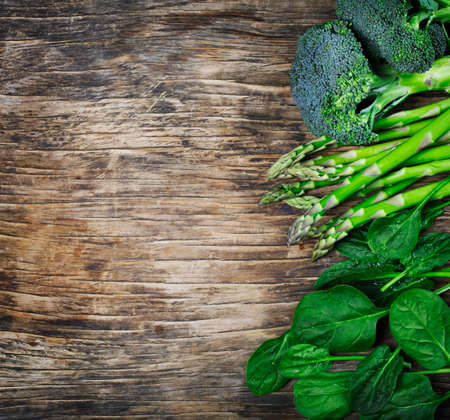 Fresh green vegetables on wooden background with copy spaceの写真素材