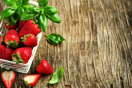Fresh strawberries and basil on wooden background with copy spaceの写真素材