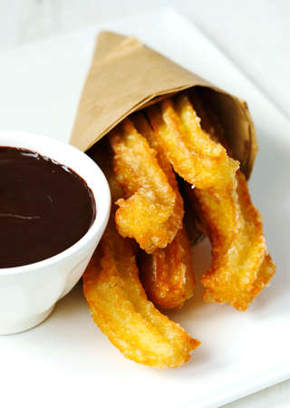 Traditional mexican dessert churros with chocolate sauceの写真素材