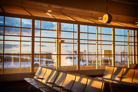 Empty airport terminal lounge with airplane on background.の写真素材