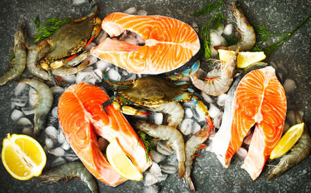 Fresh seafood, salmon steak, shrimps on stone with copy spaceの写真素材