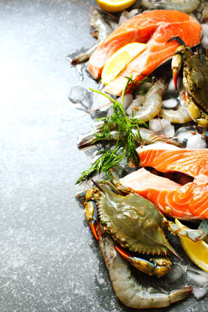 Fresh seafood, salmon steak, shrimps on stone with copy spaceの写真素材