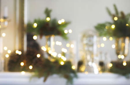 Christmas decorated fireplace with festive bokeh lighting, blurred holiday backgroundの写真素材