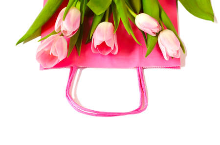Pink paper shopping bag with beautiful pink tulips bouquet, Spring Sale, top viewの写真素材
