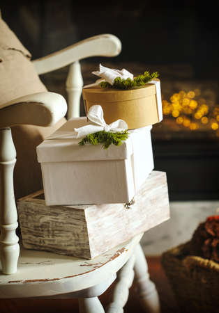 Christmas gift boxes with ribbons on a chairの写真素材