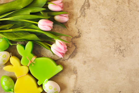 Easter background with pink tulips, eggs and bunny decoration, top viewの写真素材