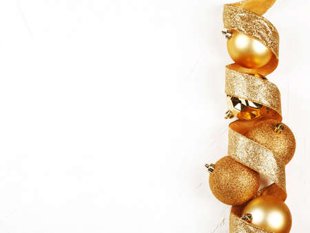 Christmas background with gold ornaments on white background, copy spaceの写真素材