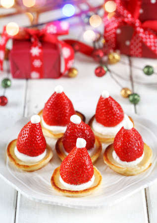 Santa Claus pancakes with whipped cream and strawberries, Christmas food ideaの写真素材