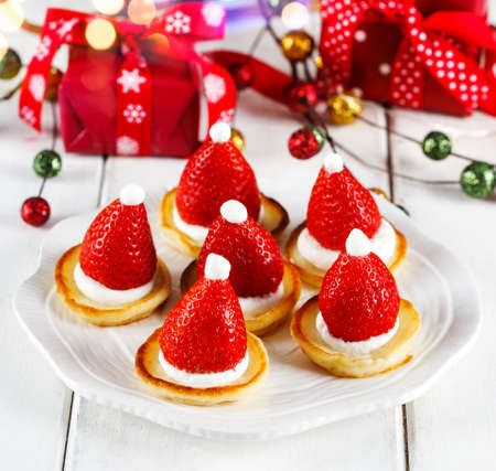 Santa Claus pancakes with whipped cream and strawberries, Christmas food ideaの写真素材