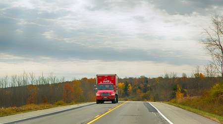 Warren, Pensylvania, USA, October 24, 2019: Coca Cola Truck driving on the road in rural autumn landscape. Coca Cola Truck driving on the road in rural autumn landscape.のeditorial素材