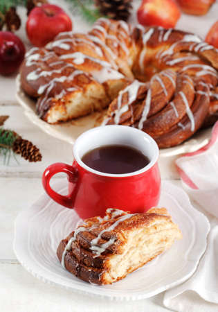Cinnamon Sweet Brioche on wooden table and cup of teaの写真素材