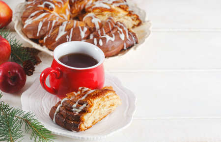 Cinnamon Sweet Brioche on wooden table and cup of tea, copy spaceの写真素材