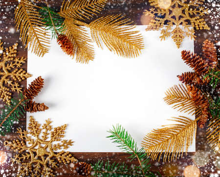 Christmas background with fir tree branch and golden ornaments. Free space for text or design.の写真素材