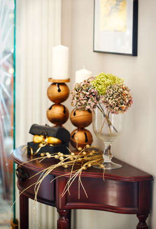 Christmas decoration with flowers and candle on tableの写真素材