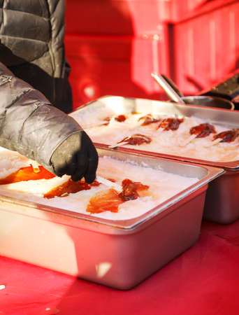 Making a maple syrup candy. Traditional canadian winter dessertの写真素材