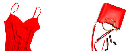 Women's set of fashion accessories in red color on white background: dress, handbag and cosmetics. Top view. Fashion concept, copy spaceの写真素材