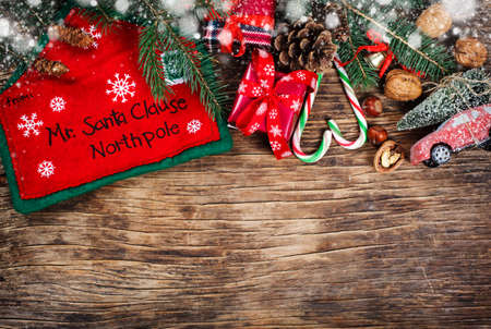 Letter to Santa Claus concept. Christmas decoration on wooden background, top view, copy spaceの写真素材