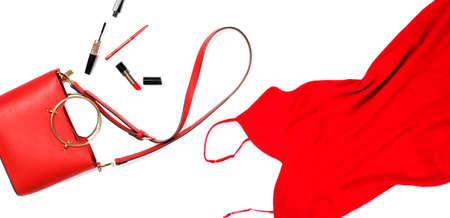 Women's red dress and handbag with cosmetics. Top view. Fashion concept, copy spaceの写真素材