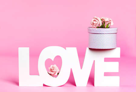 Word Love and gift box at pink color backgroundの写真素材