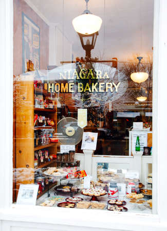 NIAGARA ON THE LAKE,CANADA - DECEMBER 2, 2019: Shop window with home baking located in the Queen Street, Niagara on the Lake, Ontario, Canadaのeditorial素材