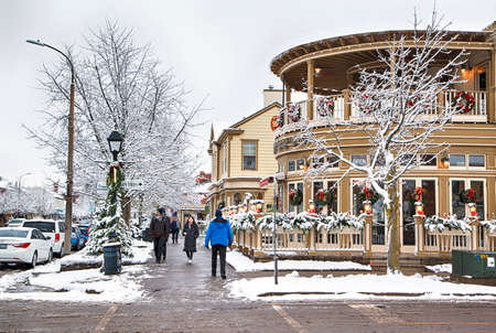 NIAGARA ON THE LAKE,CANADA - DECEMBER 2, 2019: Tourists on the famous beautiful street of Niagara on the Lake near amous restaurant Shaw Cafe & Wine Bar, Otario, Canadaのeditorial素材