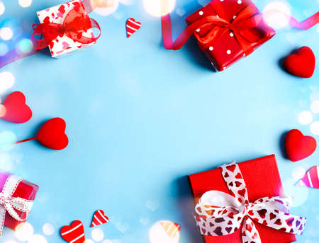 Holiday gifts. Red gift boxes on blue background. Valentines day concept. Top view, copy spaceの写真素材