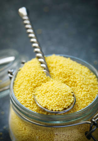 Uncooked couscous in a glass jar, selective focusの写真素材
