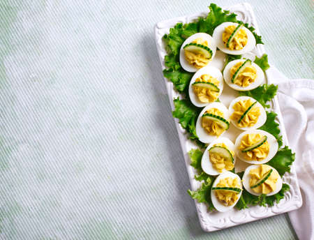 Deviled Eggs with Cucumber as an Appetizer, top view, copy space