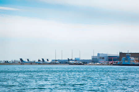 TORONTO, ONTARIO - APRIL 18, 2020: A planes are staying at Billy Bishop Toronto City Airport on April 18, 2020 in Toronto, Canada during Coronavirus pandemic. Billy Bishop Toronto City Airport located on the Toronto Island.のeditorial素材