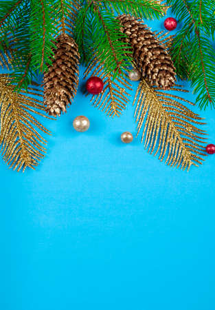 Christmas background with fir tree, pine cones and golden decoration, copy space.の写真素材