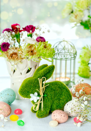 Easter decoration with Easter bunny, eggs and flowers on table. Easter Table decorating.の写真素材