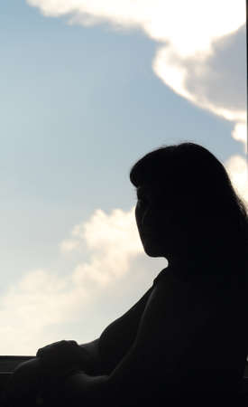 silhouette of a girl at the windowの写真素材