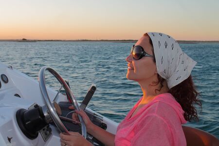 girl driving a yachtの写真素材