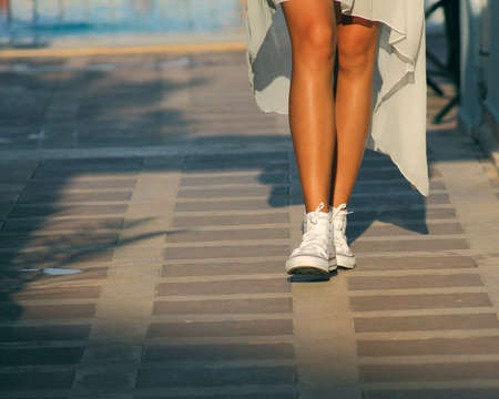 legs of the girl in sneakersの写真素材