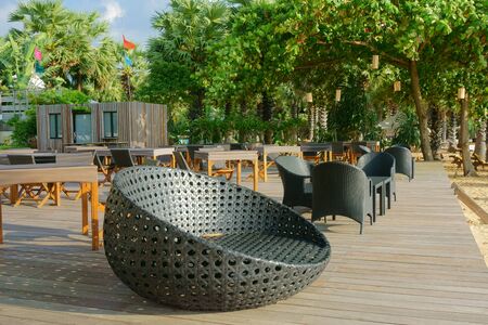 wicker furniture armchairs and a table outdoorsの写真素材